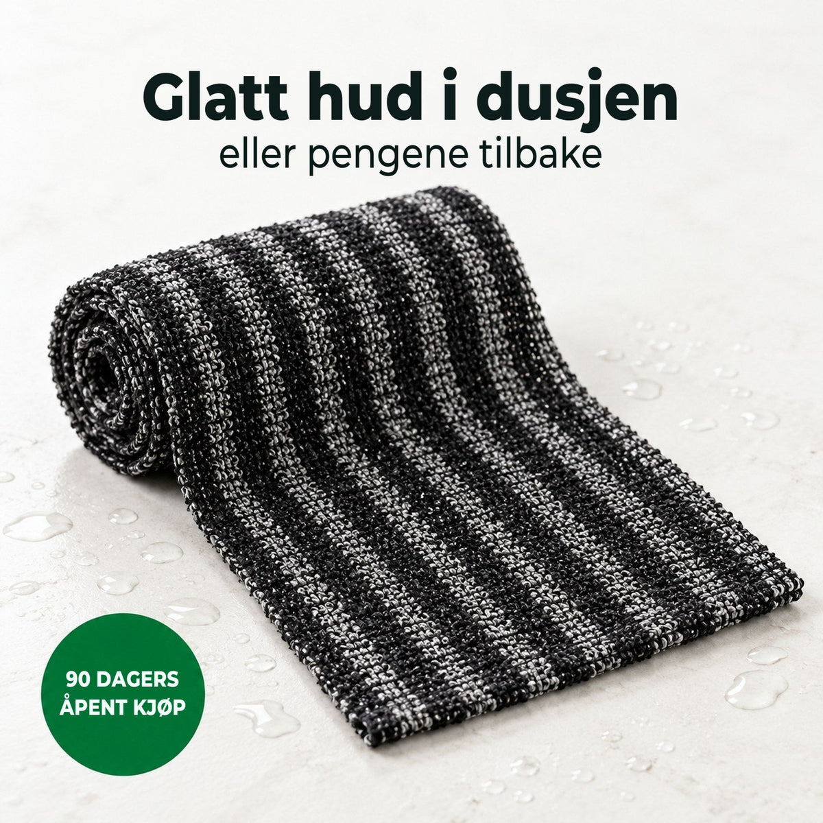 Soldahl Glattro eksfolierende dusjhåndkle i svart, rullet sammen med vanndråper
