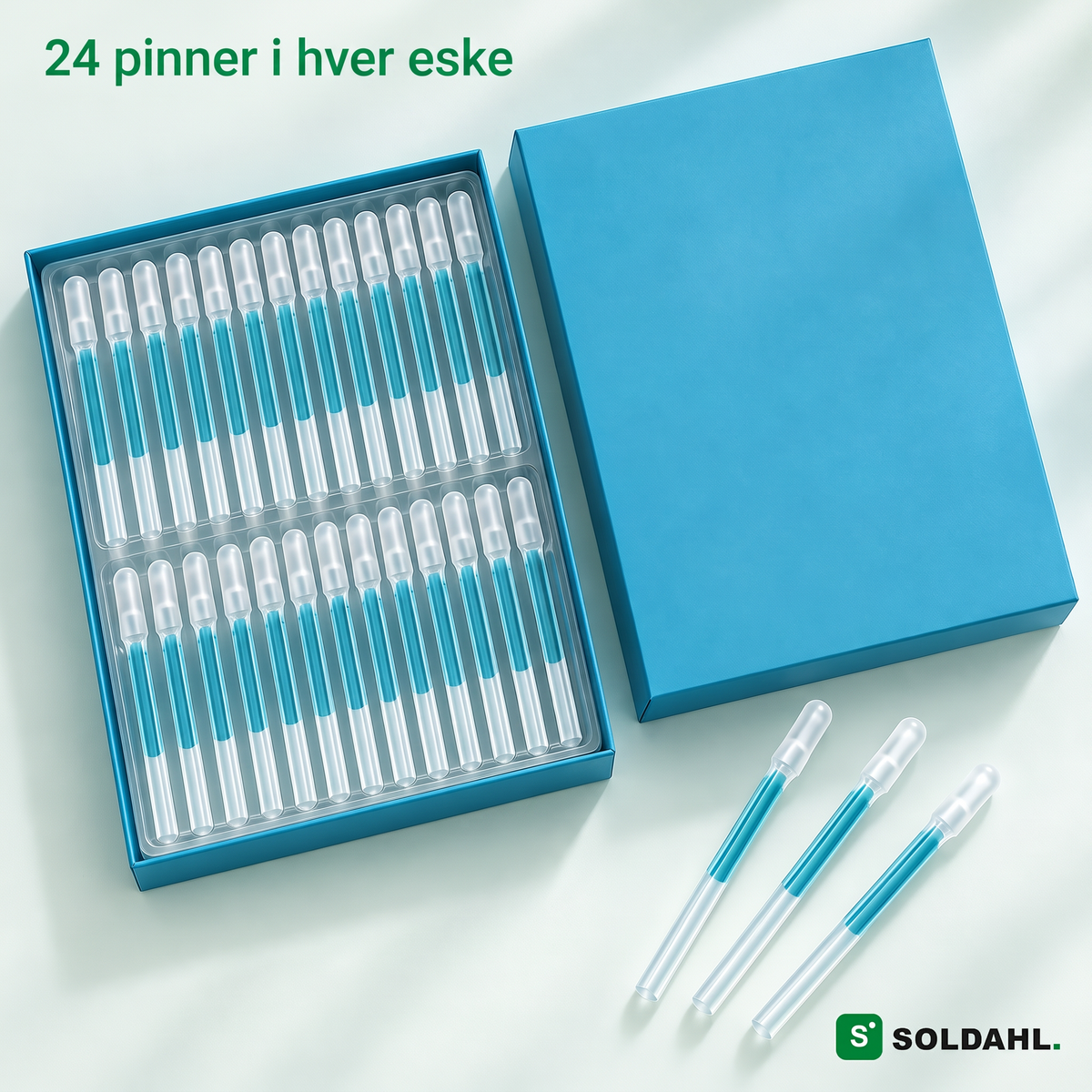 Åpen eske med 24 pinner i brett og tre løse pinner, teksten 24 pinner i hver eske